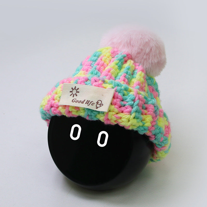 The Mixed PG beanie is knitted in a mix of pink, yellow and mint green.