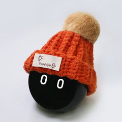 Orange hat with ginger color furball.