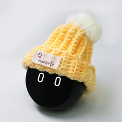 Yellow hat with white ball.